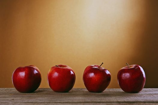 Red apples on a wooden table