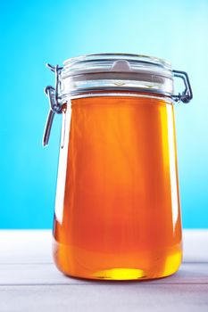 Polish jar of honey flower on a blue background