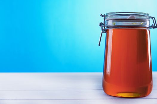 Polish jar of honey flower on a blue background