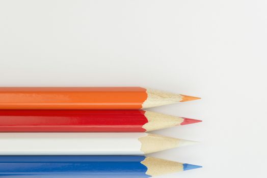 Collection of colorfull pencils in the colors of the Dutch flag as a background picture
