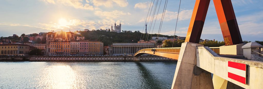 Cloudy sunset over Vieux Lyon and Fourviere Basilica seen from the riverbank of the Saone, Lyon.