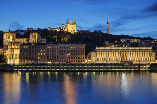 Night view over the Saone river to the Fourviere cathedral in Lyon city.