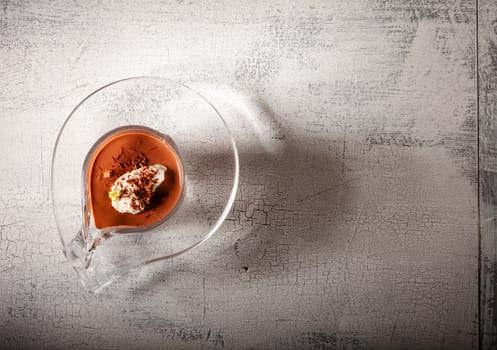 Glass with Chocolate Mousse Dessert served on a wooden surface