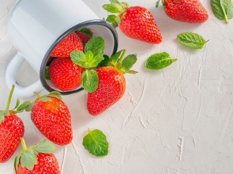 Fresh red strawberries in metal cup. Strawberry in rustic cup on oriental white background. Top view or flat lay