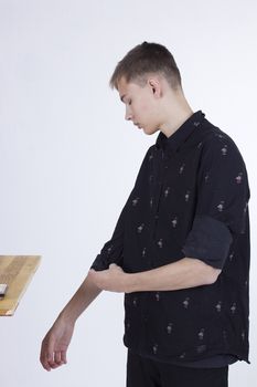 Young man makeup artist at work on a white background