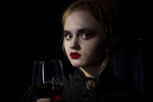 Young girl vampire on a black background