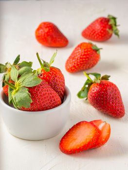 Fresh ripe strawberries in small white bowl. Strawberry in bowl on oriental white background