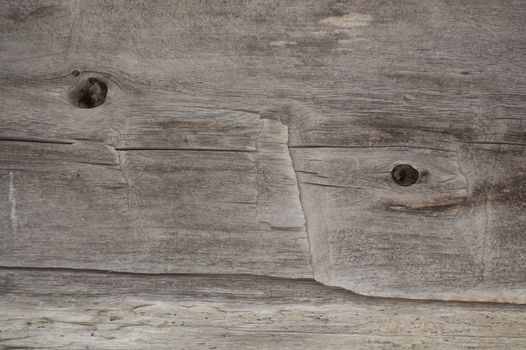 Old log cabin wood timber closeup with wood grain and adze marks. Background