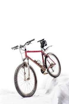 red hardtail mountain bike in a very dirty condition