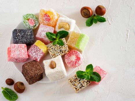 Turkish delight on white rustic background. Turkish deligh set. Assorted traditional turkish delight on oriental background