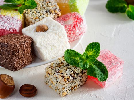 Turkish delight on white rustic background. Turkish deligh set. Assorted traditional turkish delight on oriental background