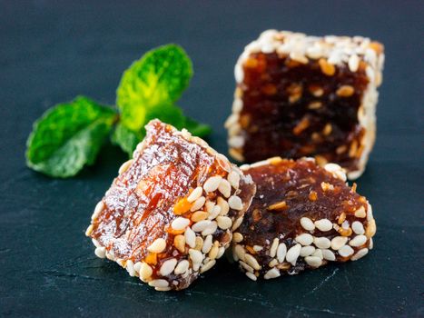 Turkish delight slice on black rustic background. Traditional turkish delight on oriental dark background close up