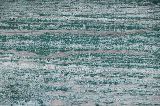 Worn white weathered painted wood with green underneath
