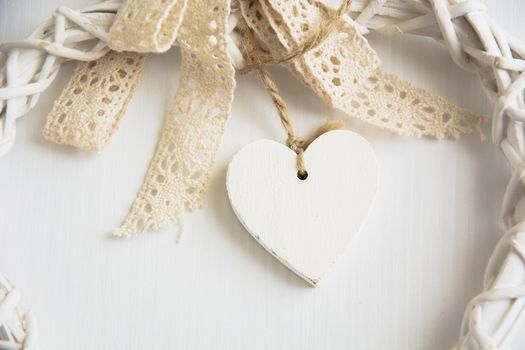 white wooden hearts placed nicely on a white wood background