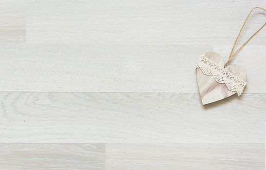 white wooden heart placed nicely on a wood background