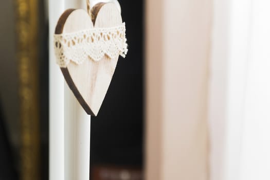 decorated wooden heart hanging in natural light