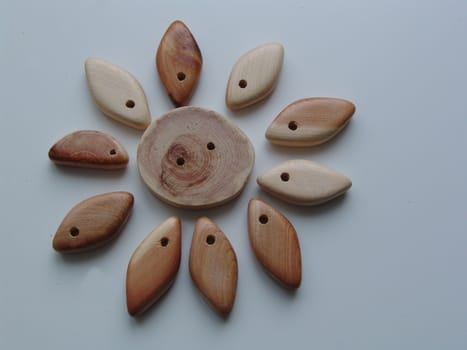 Handicraft goods,  wooden beads. Sun. Background