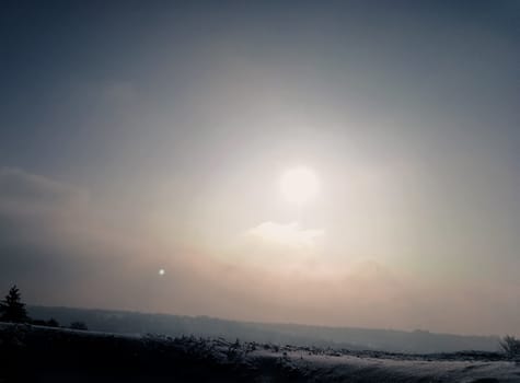 beautiful sunset on top of a hill in the winter