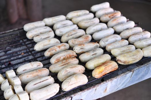 Grilled banana on the stove, food background.