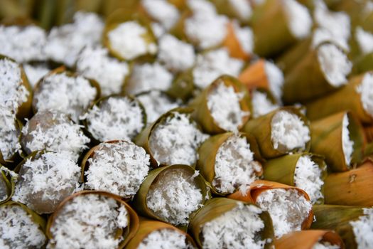 Bananas cake in leaf cone and sprinkle with coconut, Thai traditional dessert.