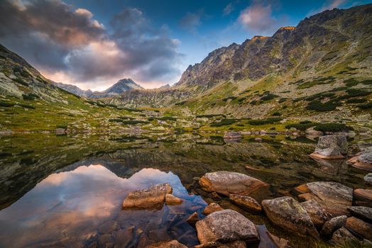 Mountain Lake Above Skok Waterfall with Rocks in Foreground and Strbsky Peak in Background at Sunset. Mlynicka Valley, High Tatra, Slovakia.