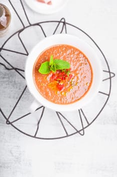 Bowl of Fresh tomato soup Gazpacho on a white background