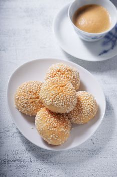 Almond cookies and coffee served on a table