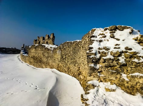 Defensive Wall Of The Old Castle On Snow Background and blue sky