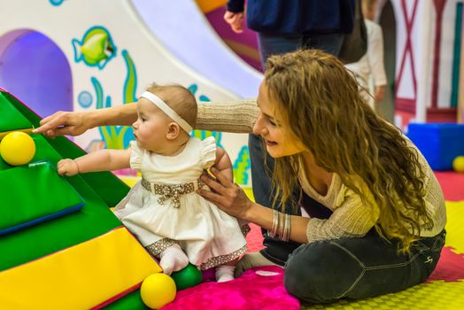 mother and child play in the children's room