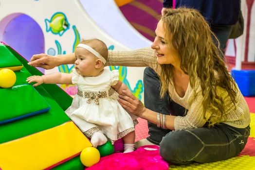 mother and child play in the children's room