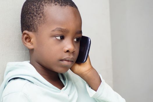 Child listening with great attention that his mother told him on the phone.