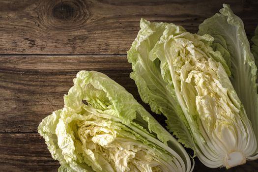 Two halves of chinese cabbage on old boards horizontal