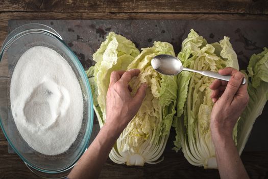 Dropping salt leaves Chinese cabbage to cook kimchi on slate horizontal