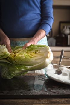 Woman salts for the preparation of Chinese cabbage kimchi vertical