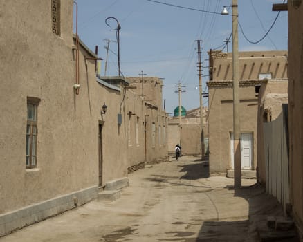 Narrow street of Itchan Kala medieval residential neighborhoods, Khiva, Uzbekistan.
