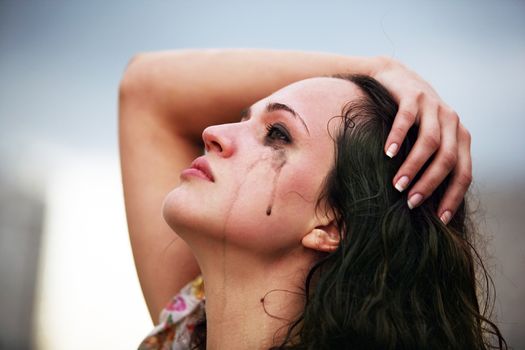 Portrait of a young crying brunette