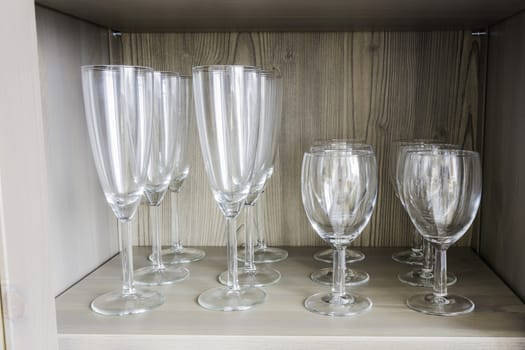 Collection of wine glasses on a wooden shelf