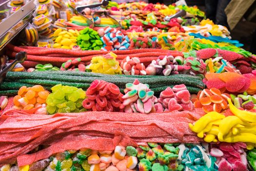 Selection of colourful candy on display at a stall in the mercado de la Boqueria, Barcelona, Spain