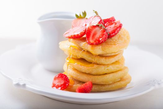 Stack of sweet pancakes with strawberry and honey. Gluten free flour.