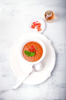 Bowl of Fresh tomato soup Gazpacho served on a table