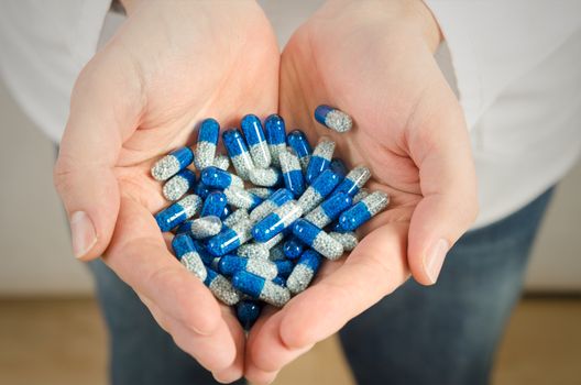 Man holds a pile of pills on a palm. pill holding health medicine hand medical vitamin illness concept