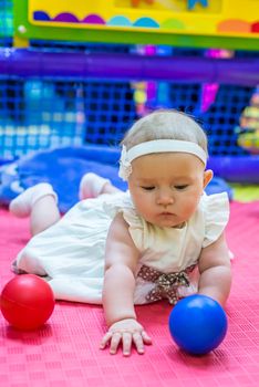 one of the babies playing in the nursery