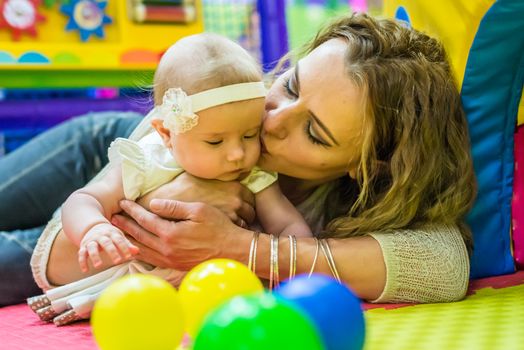 mother and child play in the children's room