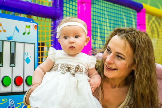 mother and child play in the children's room