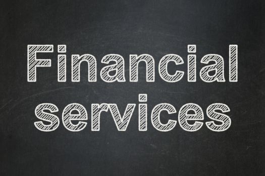 Banking concept: text Financial Services on Black chalkboard background