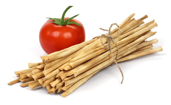 Crispy crunchy long bread sticks with tomato, isolated on a white background.