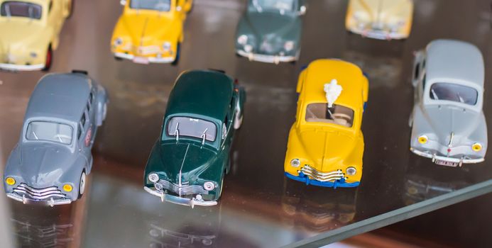 retro colorful toy sport cars on a glass stand