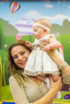 mother and child play in the children's room