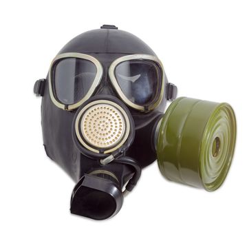 Rubber gas mask with filter mounted on side of the mask and drinking tube on a light background
