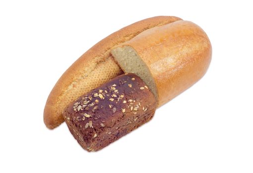 Whole long roll of bread with bran, brown whole wheat bread with grains of flax and sunflower and half of a loaf wheat bread on a light background
